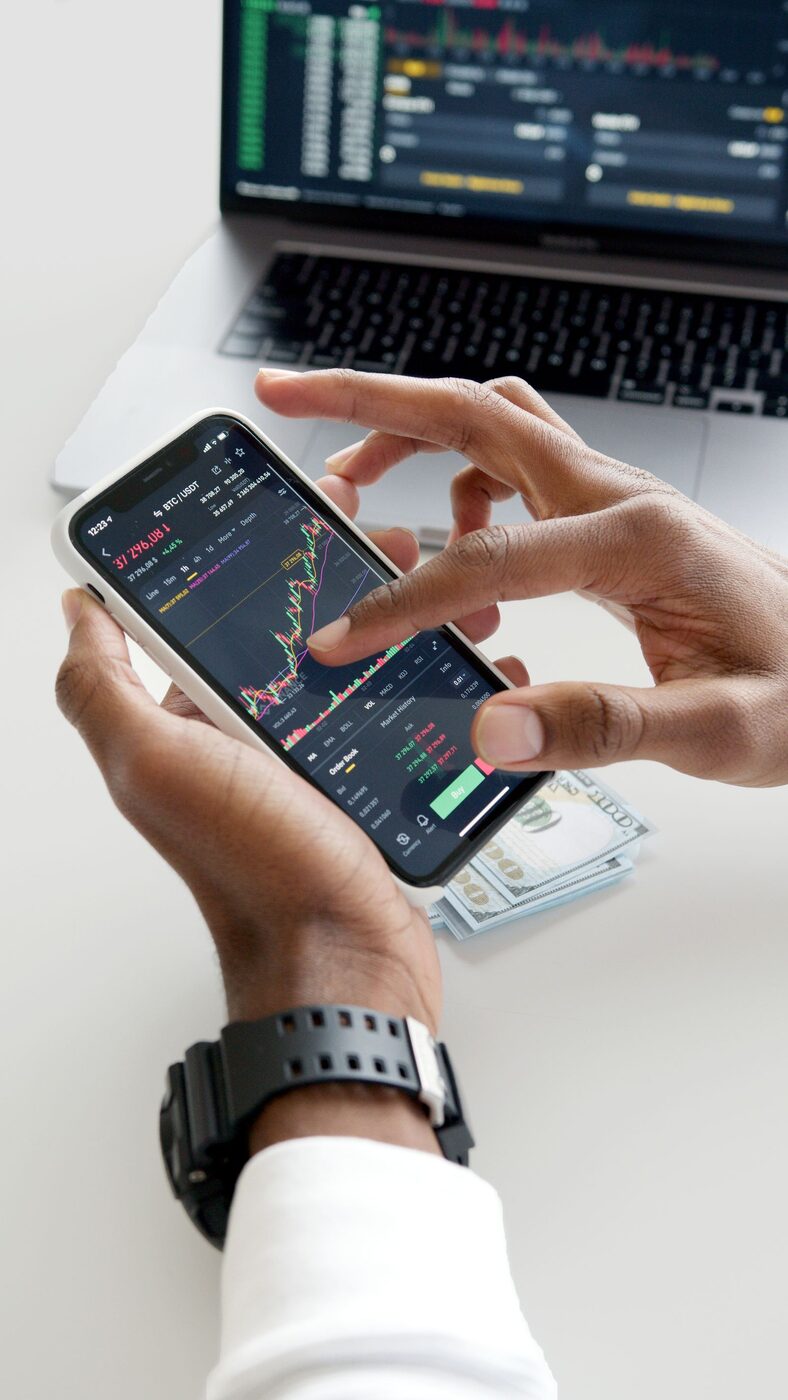 Hands pointing at a stock market display board