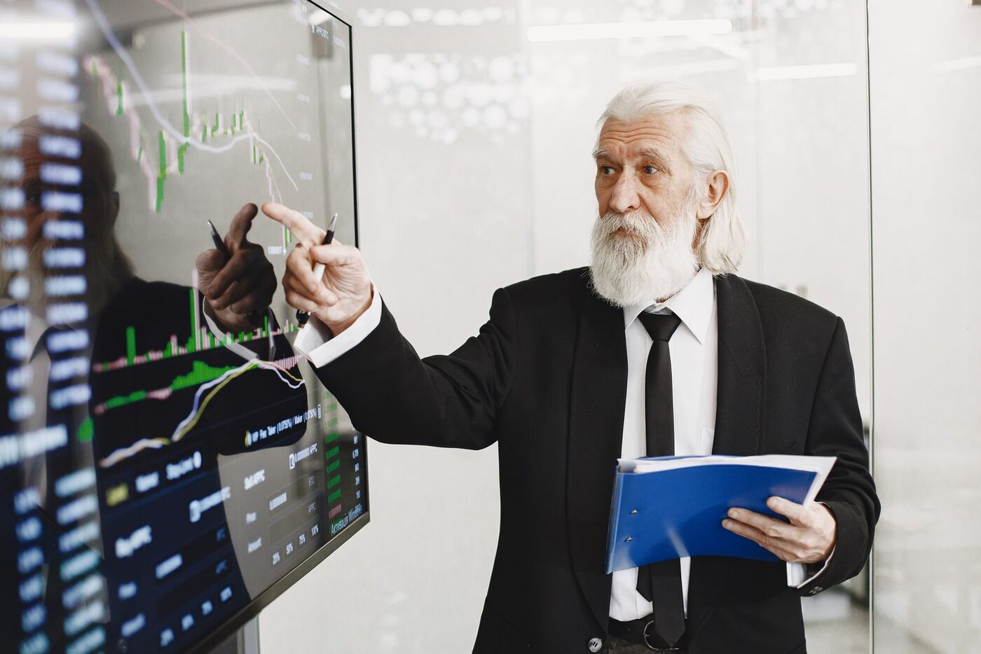 Businessman pointing at charts on a screen