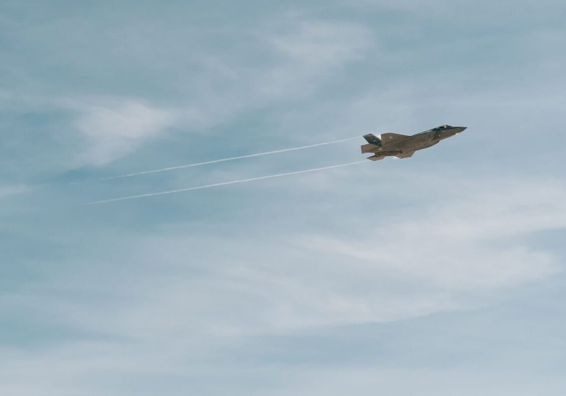 Fighter jet flying in a cloudy sky